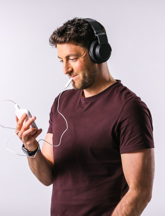 A middle aged man using the Lenire tinnitus treatment device