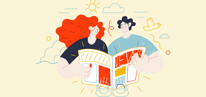 A couple looks at a magazine together over coffee on a sunny day