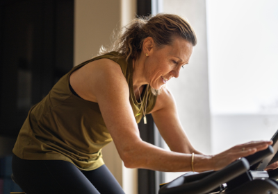 A middle-aged woman riding a stationary bike
