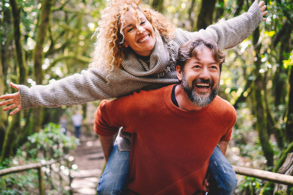 A man giving a woman a piggy-back ride